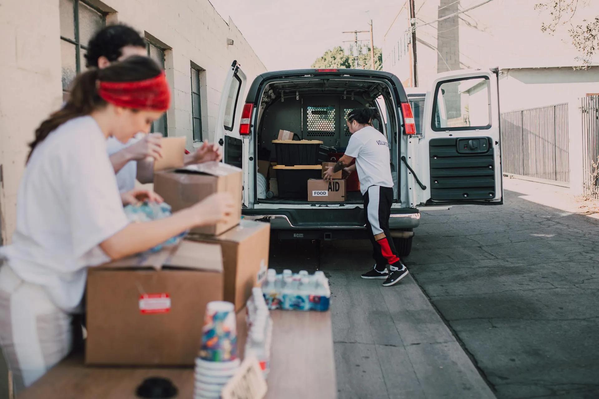Volunteers distributing supplies to families in a community Nydus Foundation serves